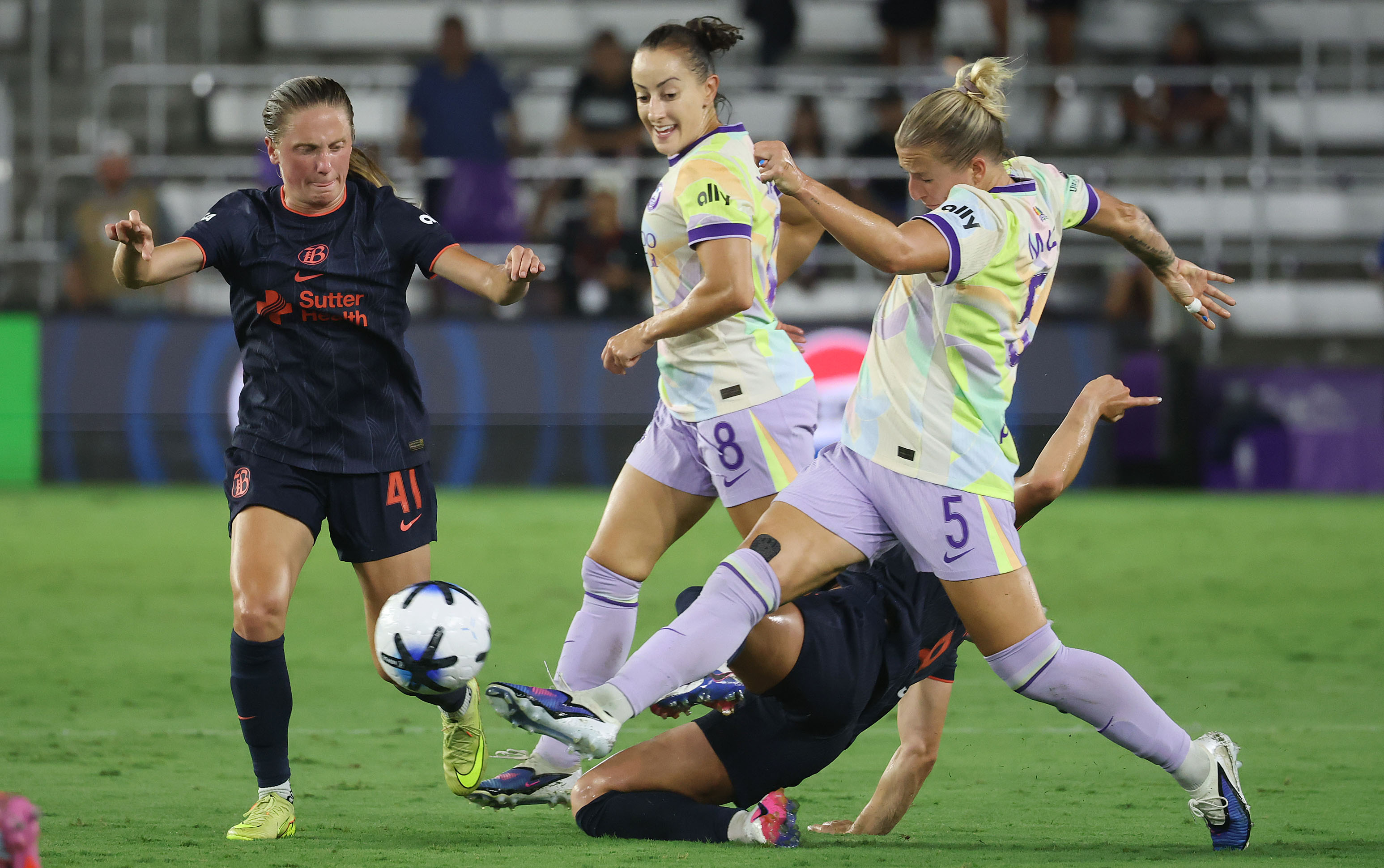 Orlando players Hailie Mace (5) and Luana (8) work to...