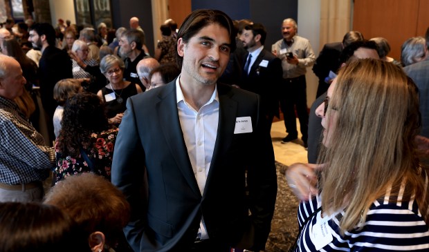 Eric Jones, Democratic challenger for the 4th Congressional District, talks with Kristine Johnson as he makes an appearance at a fundraiser in Lincoln, Wednesday, May 20, 2026. At left is campaign chief of staff Nick Sanitsky. (Kent Porter / The Press Democrat)