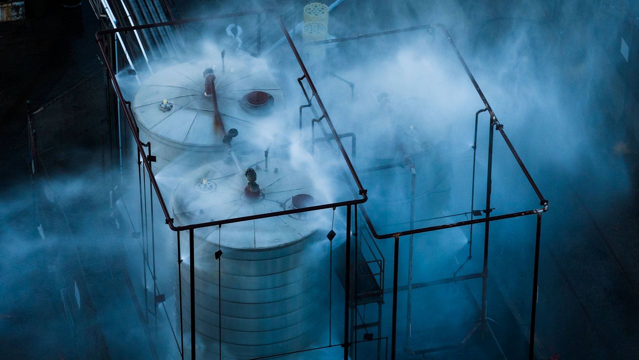 Water is sprayed on a tank that overheated at an aerospace plant in Garden Grove, Calif., Friday, May 22, 2026. (AP Photo/Ethan Swope)
