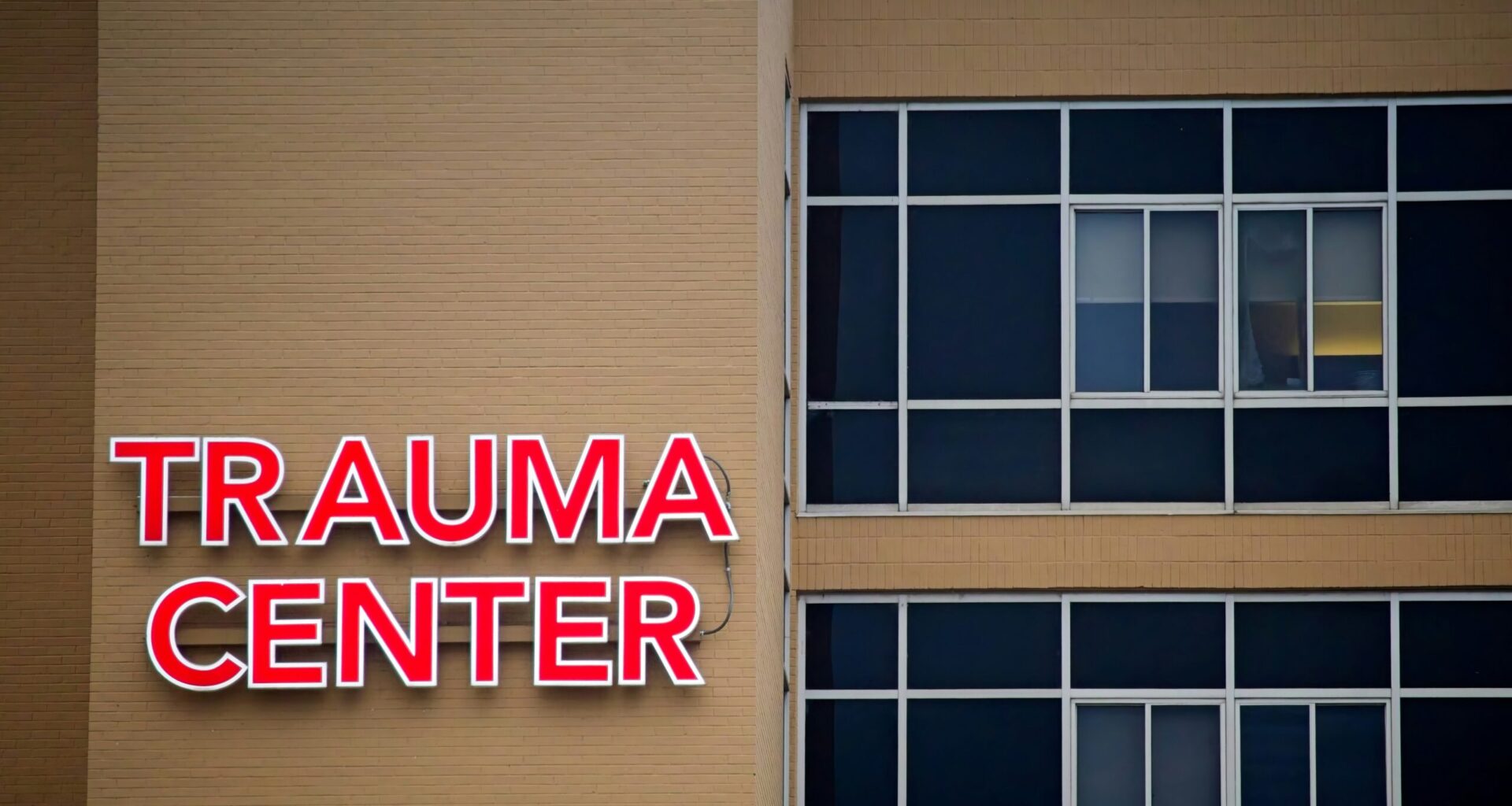 The exterior walls of a hospital with a sign that says trauma center