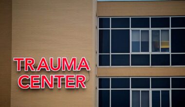 The exterior walls of a hospital with a sign that says trauma center