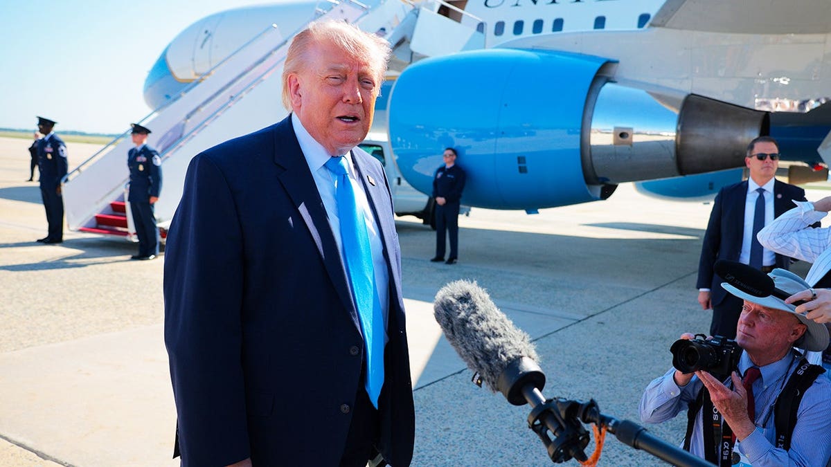 U.S. President Donald Trump talks to reporters before boarding Air Force One