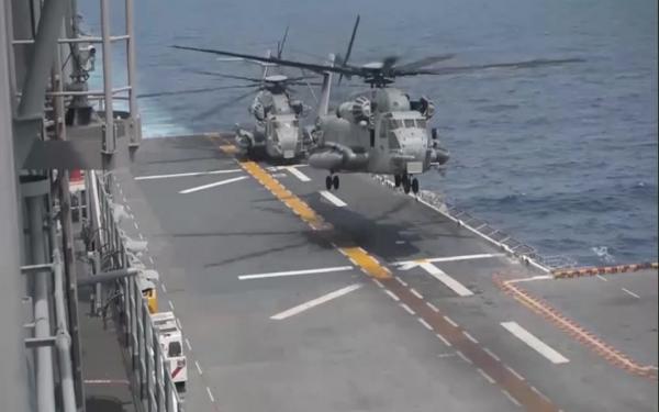 Search aircraft land aboard the USS Essex during a massive...