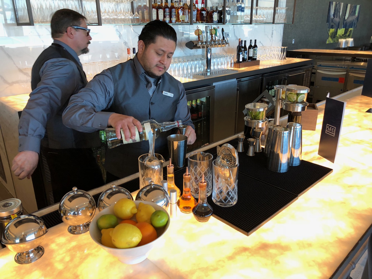 a man pouring a drink into a glass