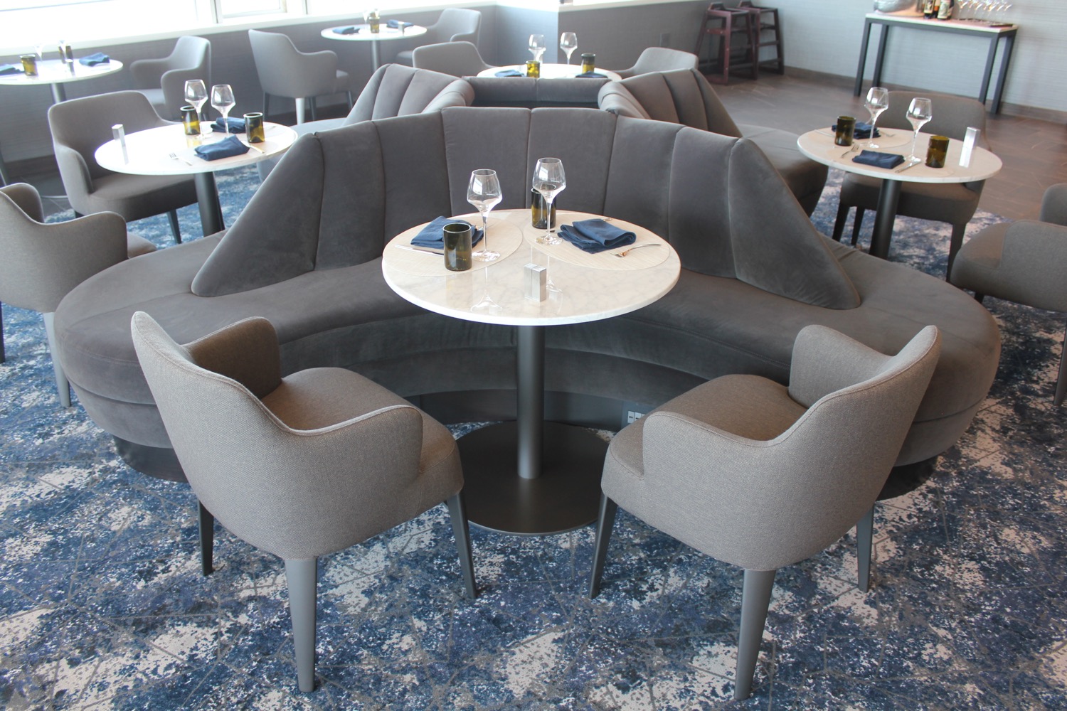 a group of tables with chairs and glasses on it