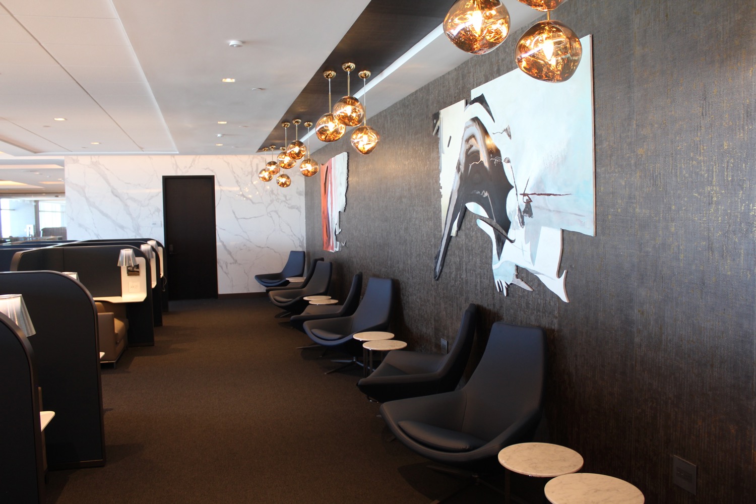 a room with chairs and art on the wall