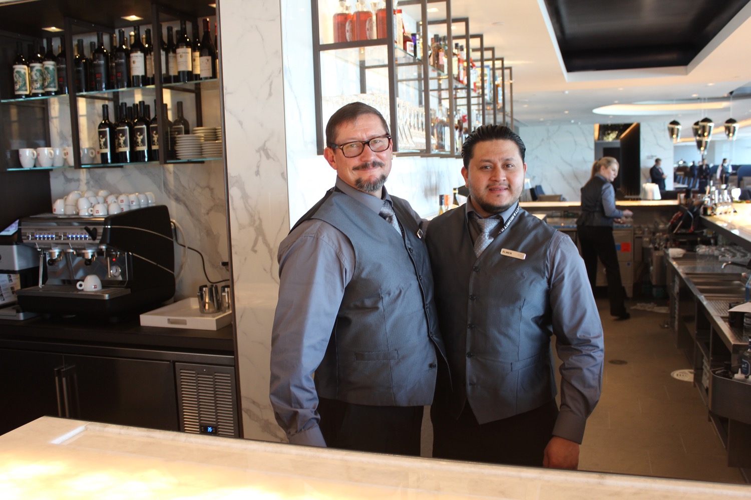 two men standing in front of a mirror