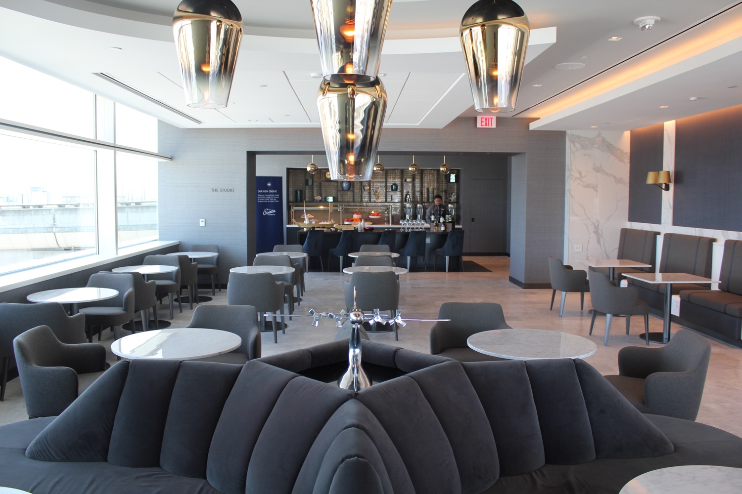 a room with a couch and tables and chairs