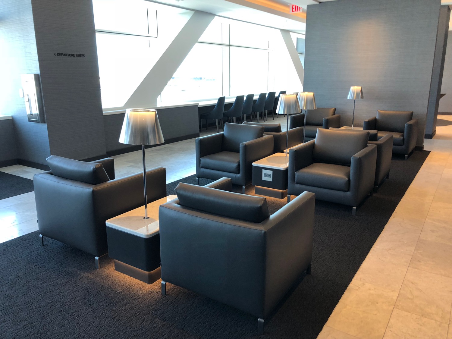 a group of chairs and a lamp in a room