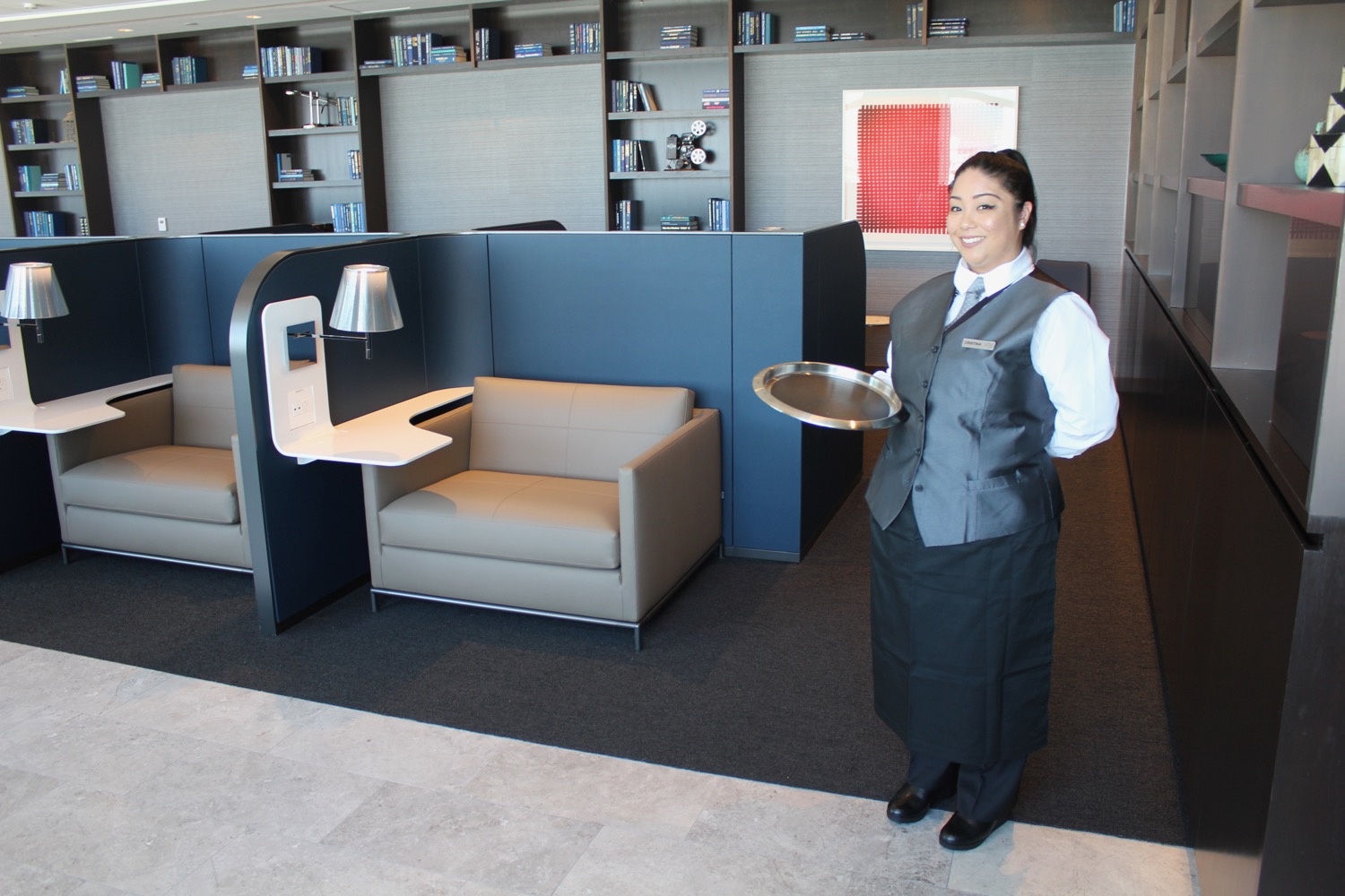 a woman holding a tray in a room