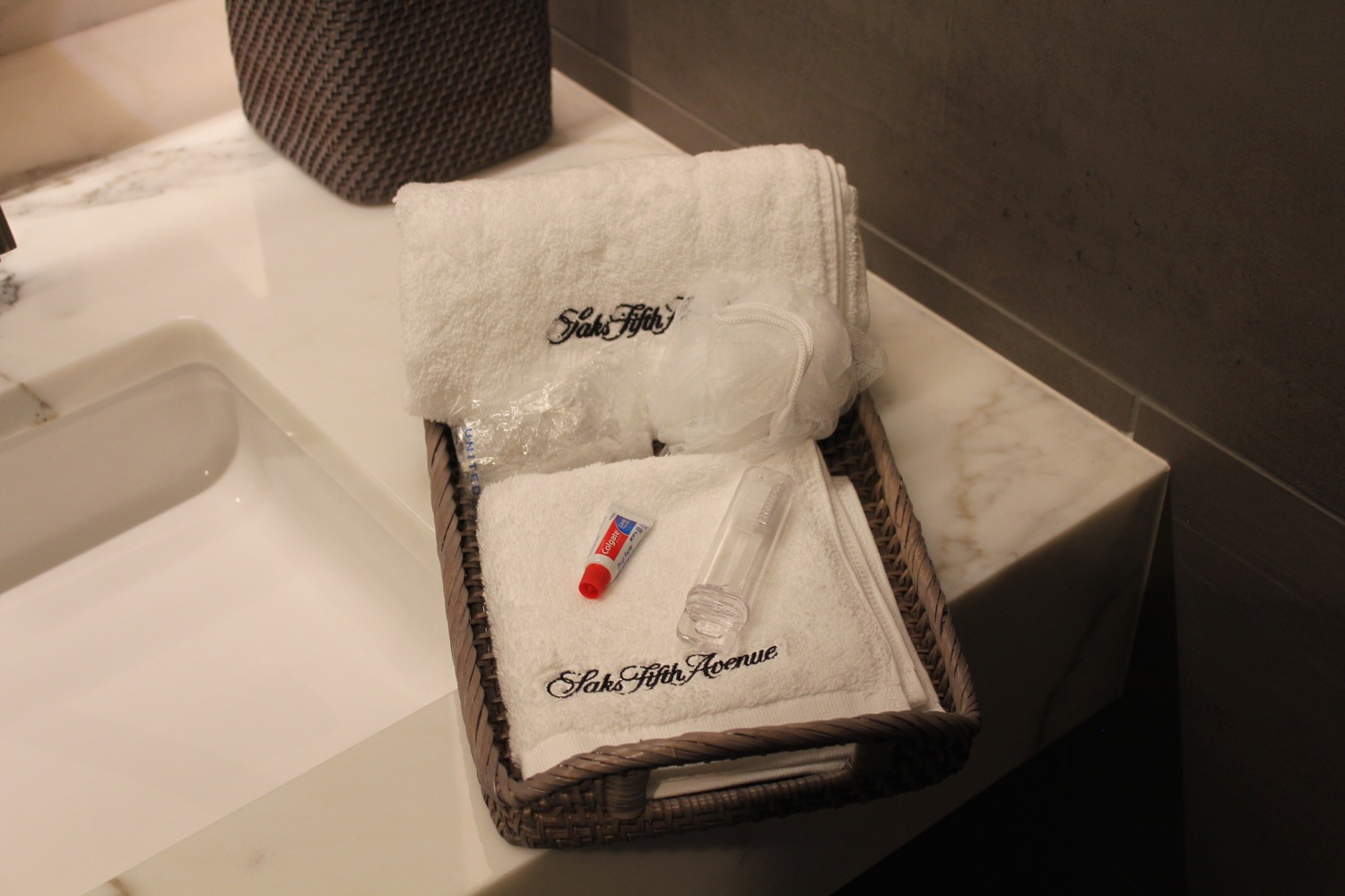 a basket with towels and a tube of lipstick
