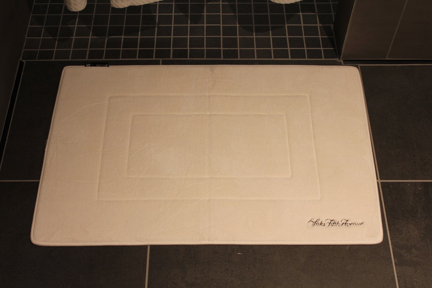 a white rug on a tile floor