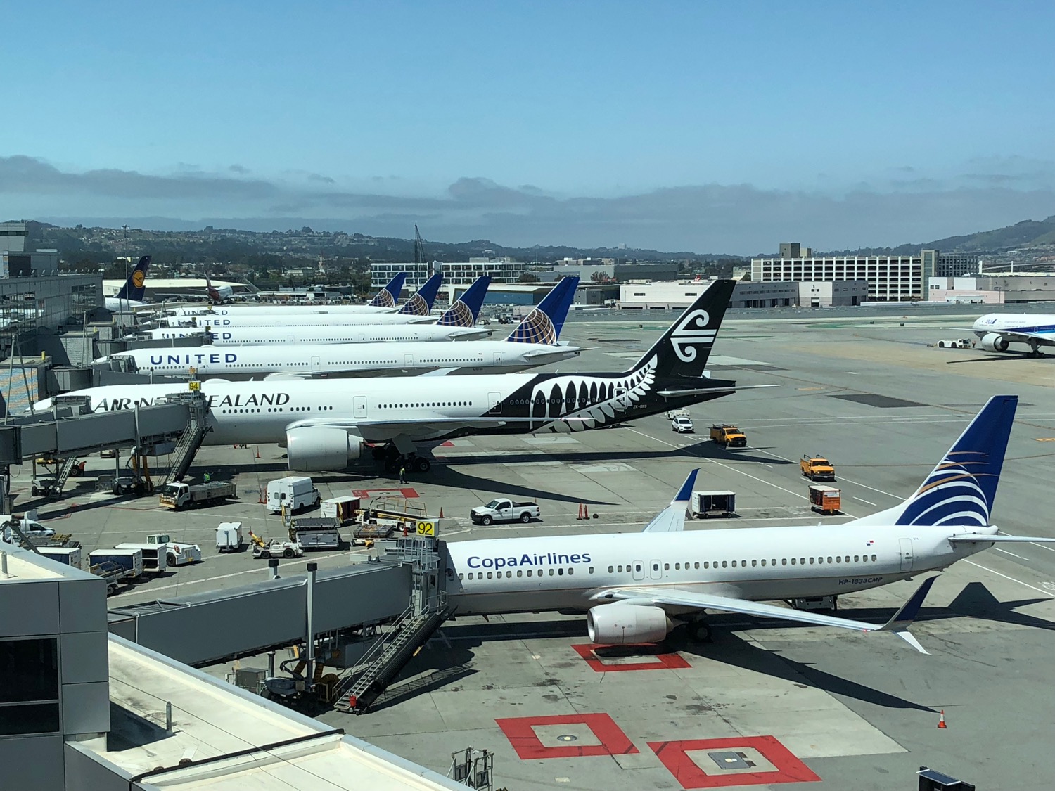a group of airplanes parked at an airport