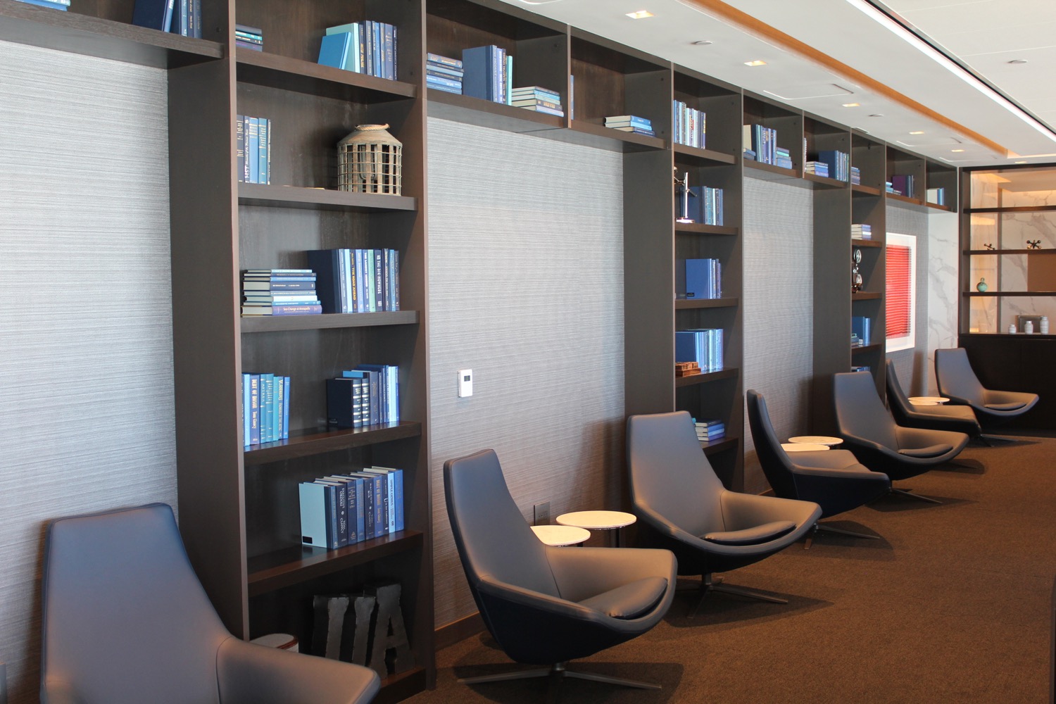 a room with bookshelves and chairs
