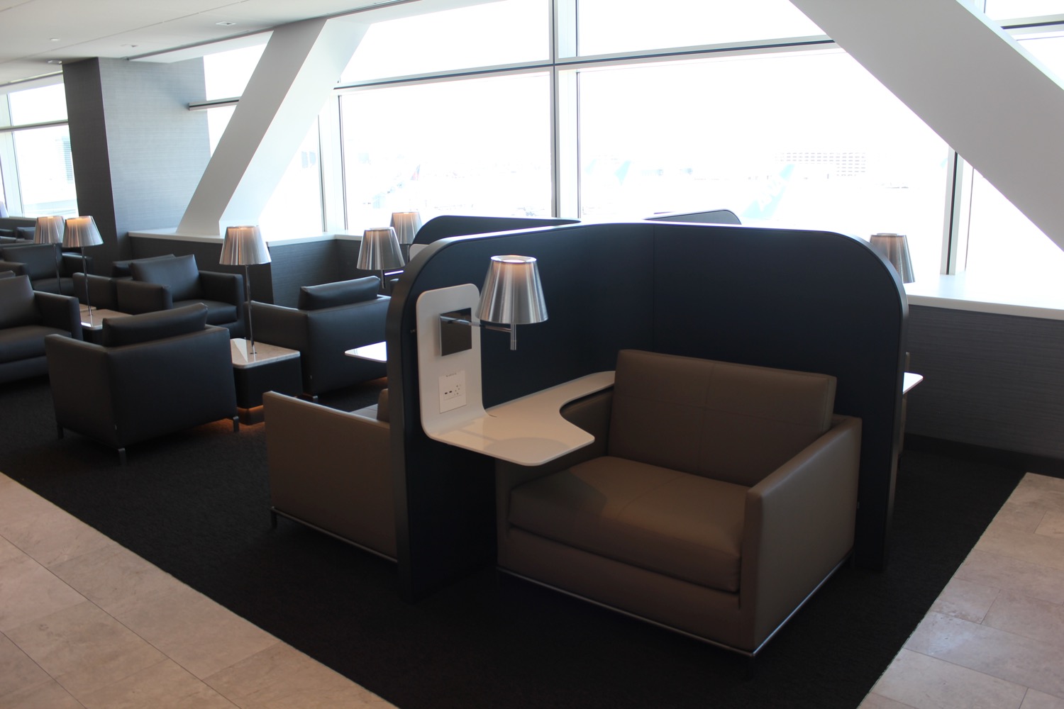 a lounge area with chairs and tables