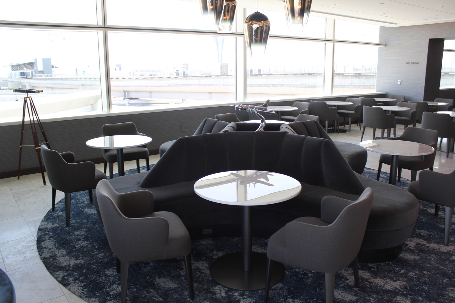 a room with a round table and chairs