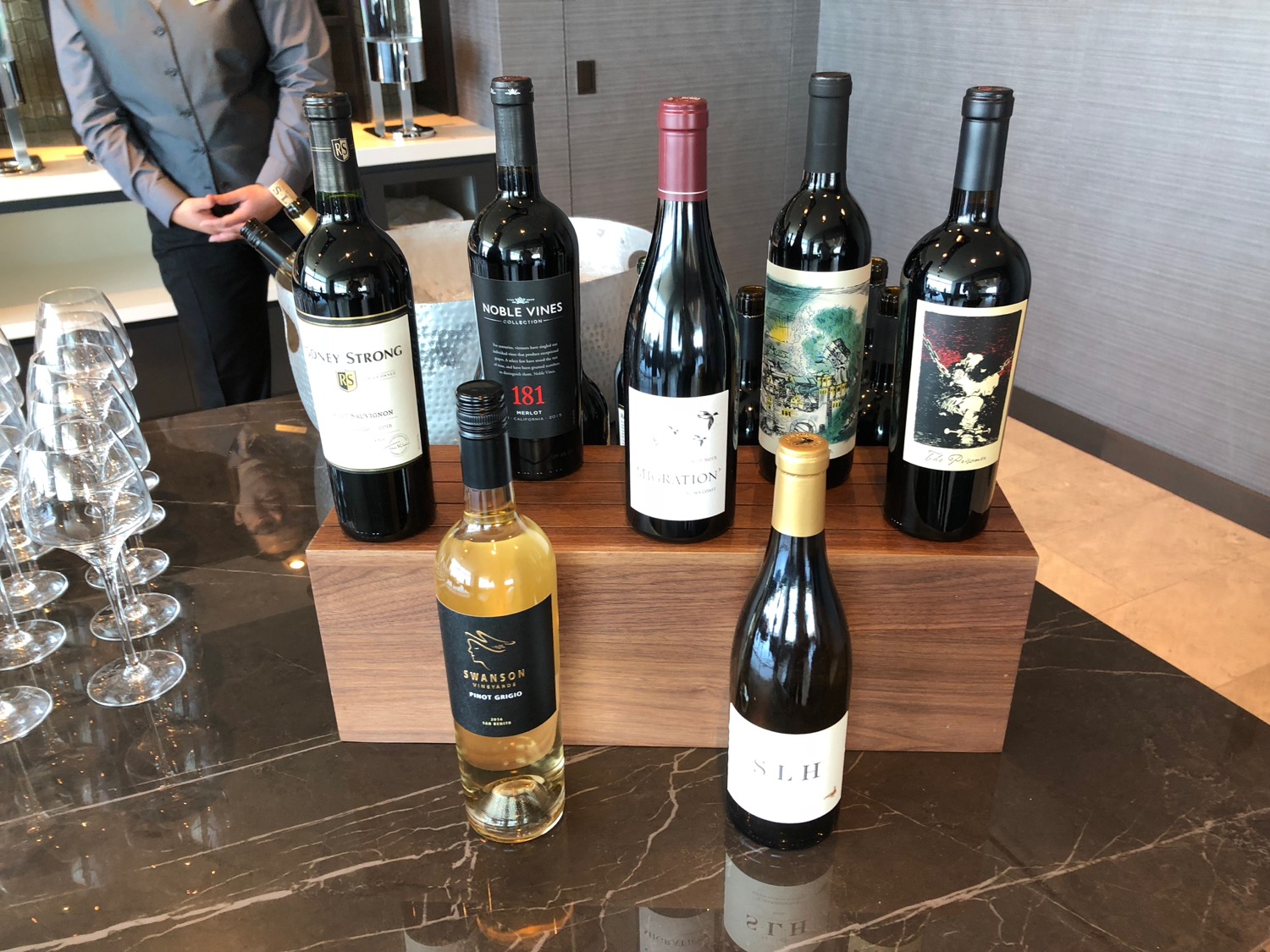 a group of wine bottles on a wooden block
