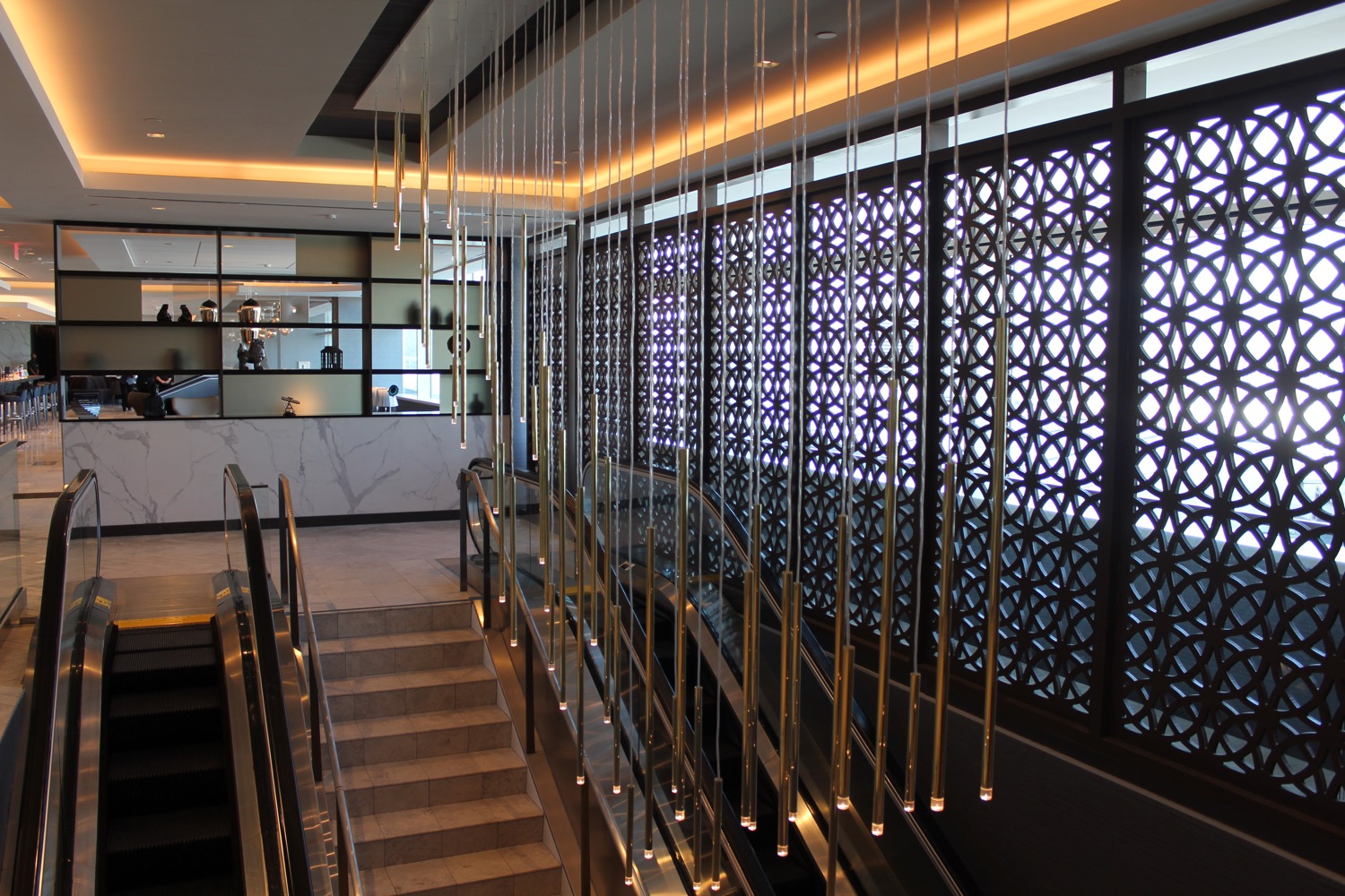 a staircase with lights from the ceiling
