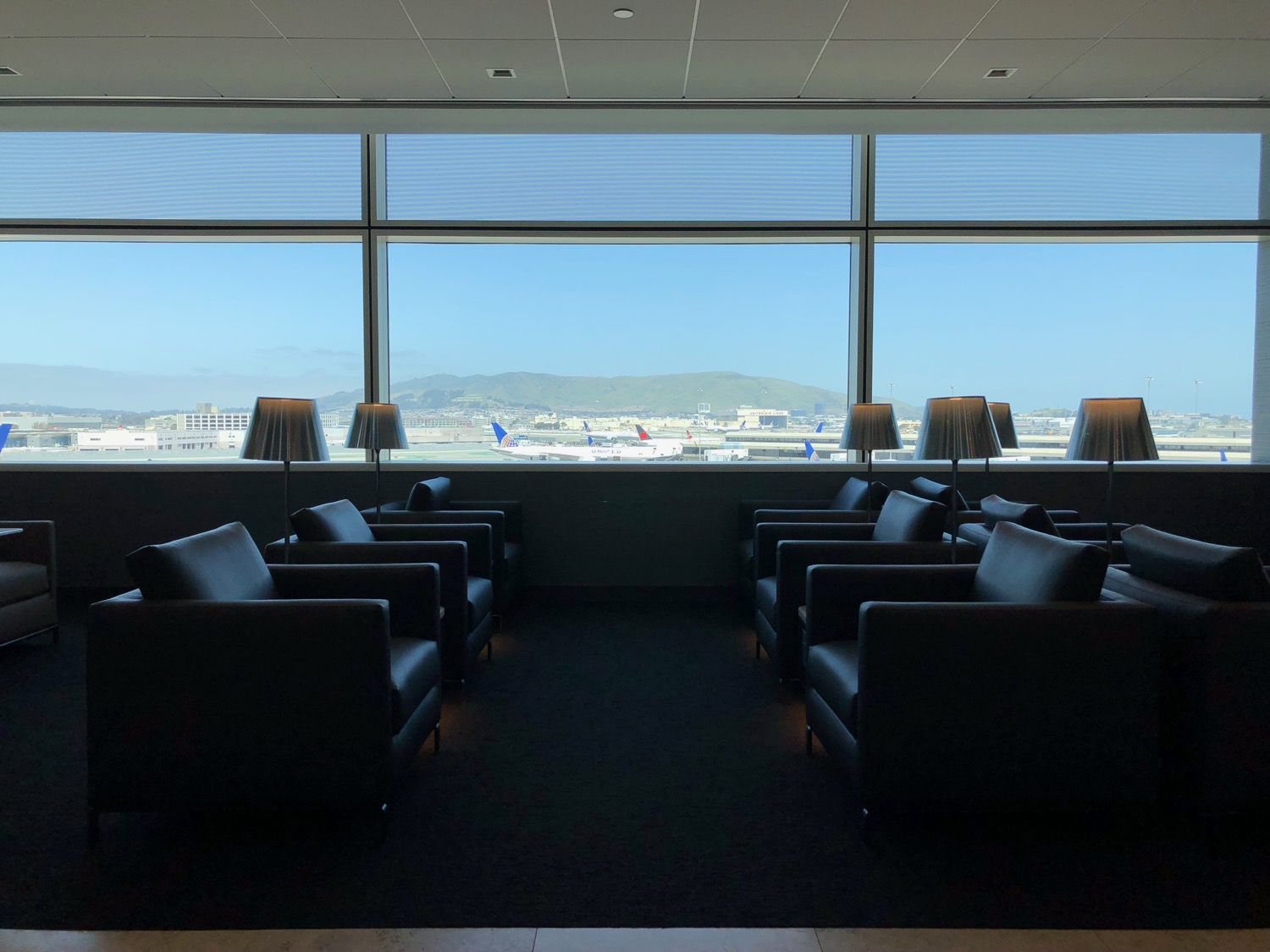 a room with black chairs and lamps