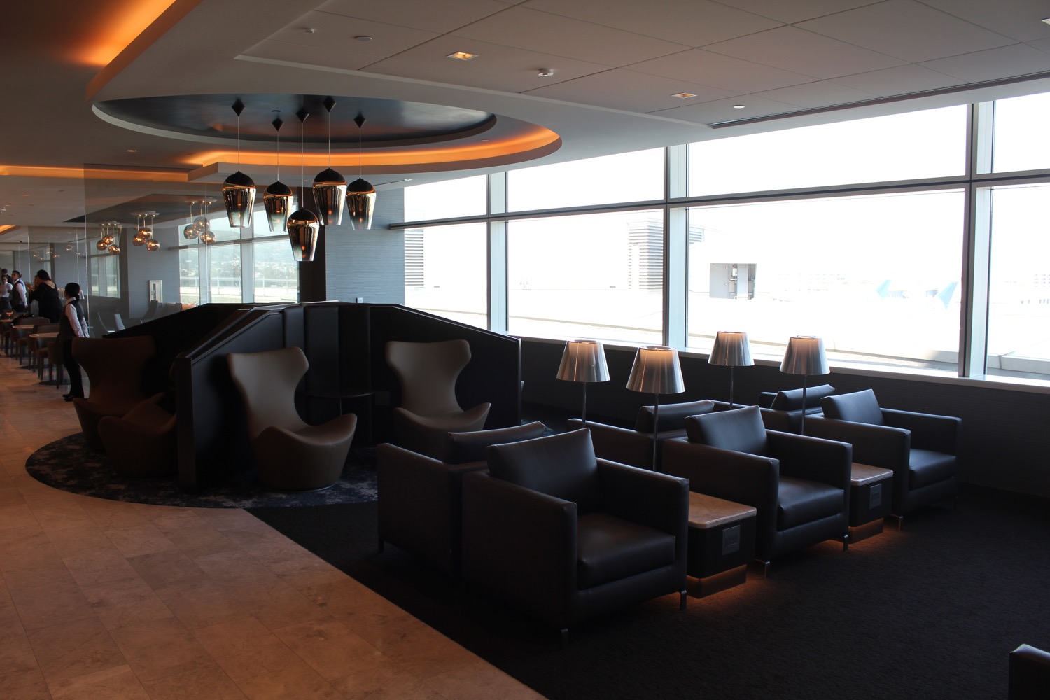 a room with chairs and a wall of windows