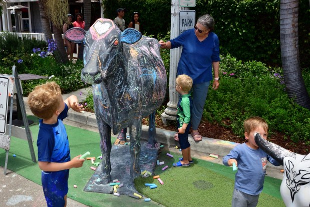 Bovine statues on Avenida de la Playa get pastel treatment during "Tides of Creativity" on June 21 in La Jolla Shores. (Vincent Andrunas)
