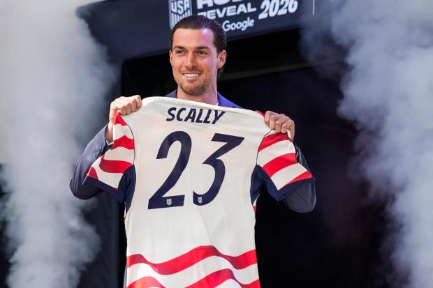 Joe Scally holds his jersey