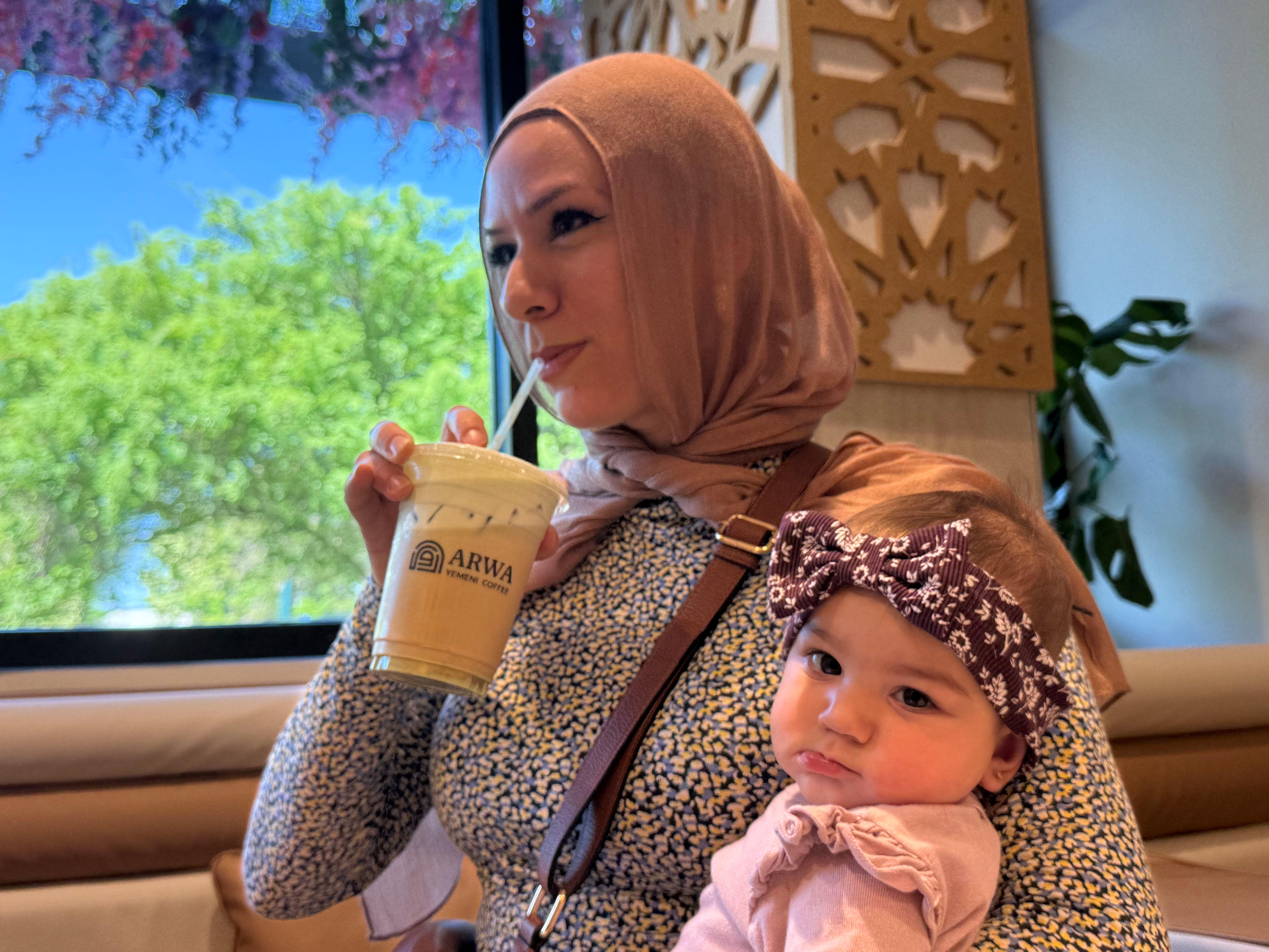 Hanan Jomaa drinks an iced pistachio latte inside Arwa Yemeni...
