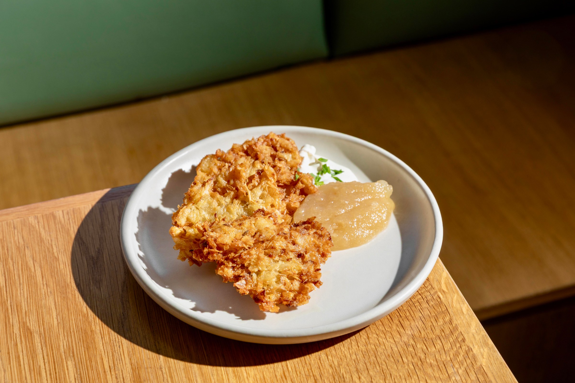 Yuca latkes on a white plate at Amiguita.