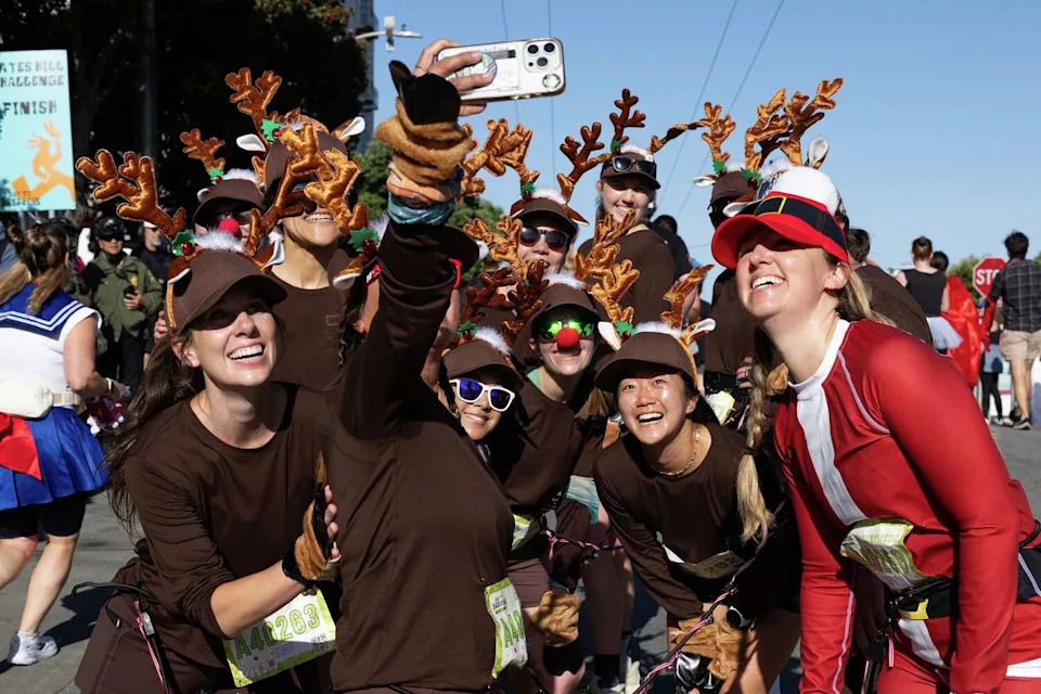 A group dressed as reindeer poses for a selfie at the top of Alamo Square during the 113th annual Bay to Breakers in San Francisco on Sunday. (Benjamin Fanjoy/For the S.F. Chronicle)