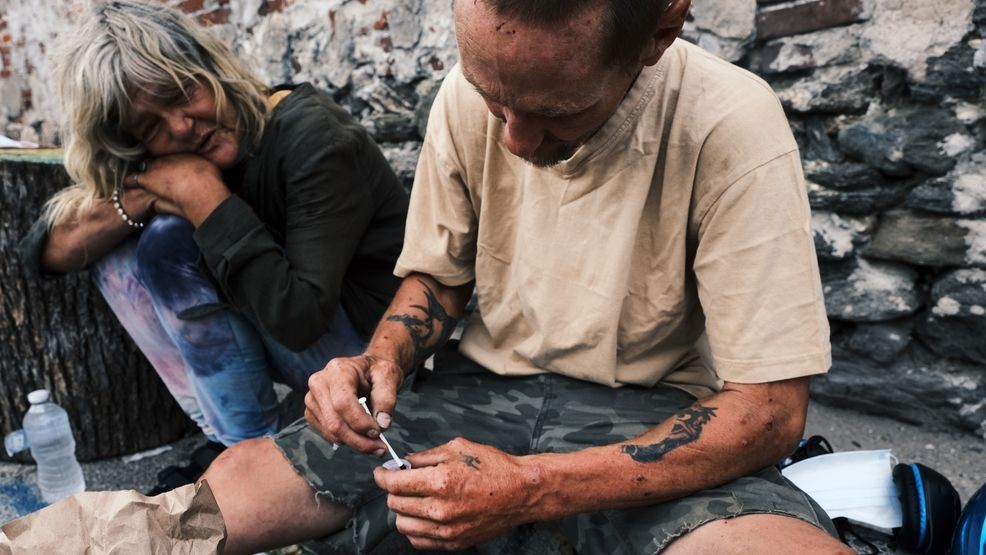 FILE - A person prepares to shoot up a mix of heroin and fentanyl on a street on July 19, 2021, in Philadelphia, Pennsylvania. (Photo by Spencer Platt/Getty Images)