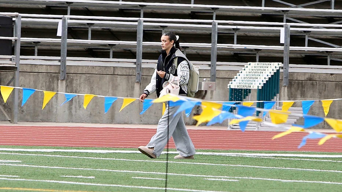 AB Hernandez walking on a football field at a championship event