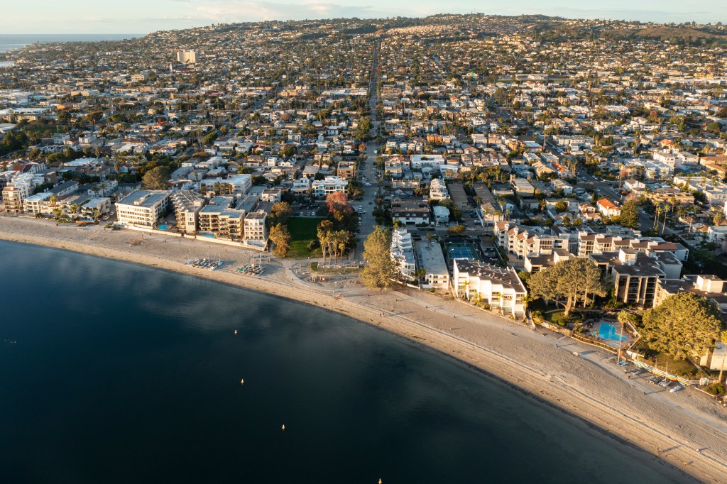 Aerial view of condominiums, apartments, and single-family homes along Sail Bay in San Diego, California.