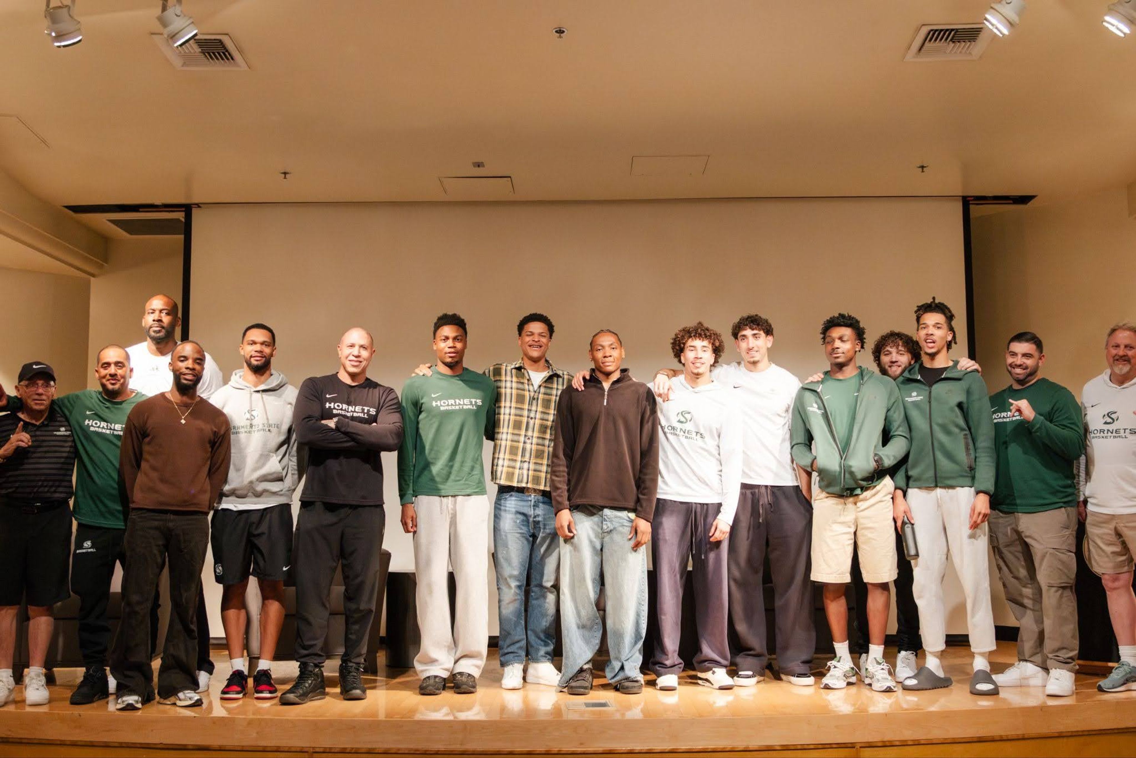 Sacramento State men's basketball team players and staff with director Dontae Putmon, fourth from left.