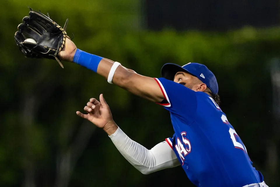 Ezequiel Durán #20 of the Texas Rangers catches a fly ball during an MLB game against the Los Angeles Angels on May 23, 2026 at Angel Stadium in Anaheim, California.
