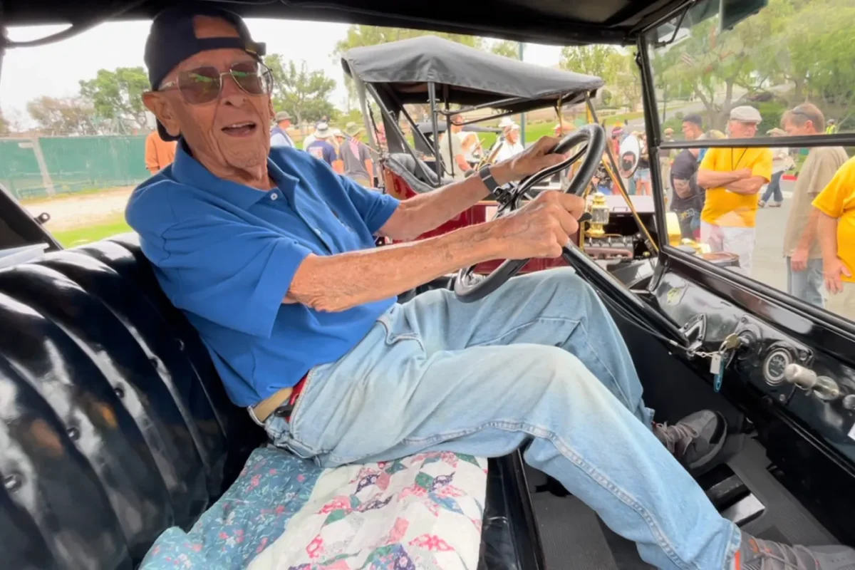 Bob Gurr behind the wheel of a Model T in 2025