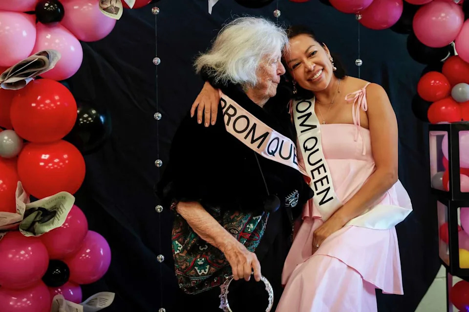 Pat Wiley and Katherine Villasin pose for a photo during Senior Prom at the County Fair Building at Golden Gate Park in San Francisco on Wednesday. (Brontë Wittpenn/S.F. Chronicle)