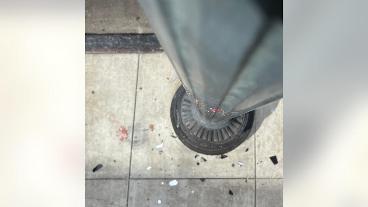 <div>Social media video showed a red Hyundai sedan driving recklessly on the sidewalk and crashing between a gate and a light post.</div>