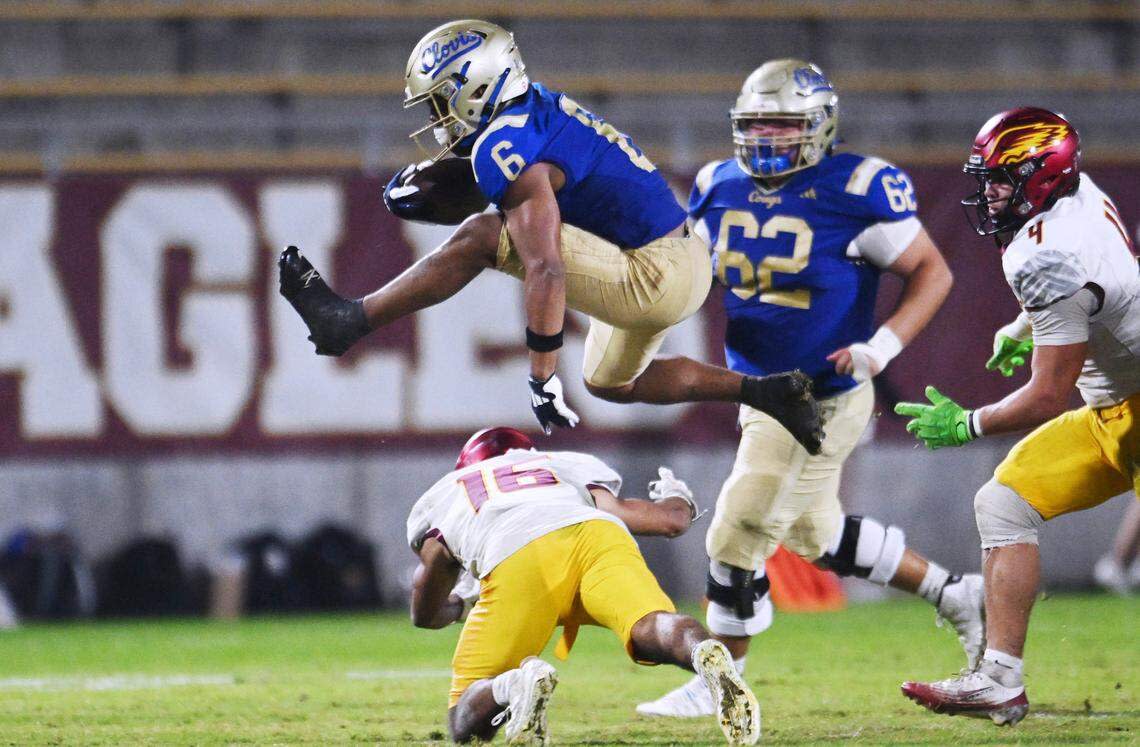 Clovis High’s James Curoso, top, hurdles over Clovis West’s Andrew Garcia, bottom in the Range Rider game held Friday, Oct. 31, 2025 in Clovis. Clovis beat out Clovis West 28–17.