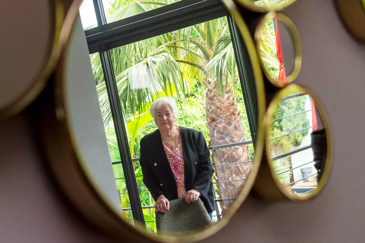 Marie-Therese Ross-Mahe, an 85-year-old French widow of a U.S. military veteran, poses in Orvault, western France, during an interview with The Associated Press, Monday, May 11, 2026. (AP Photo/Mathieu Pattier)