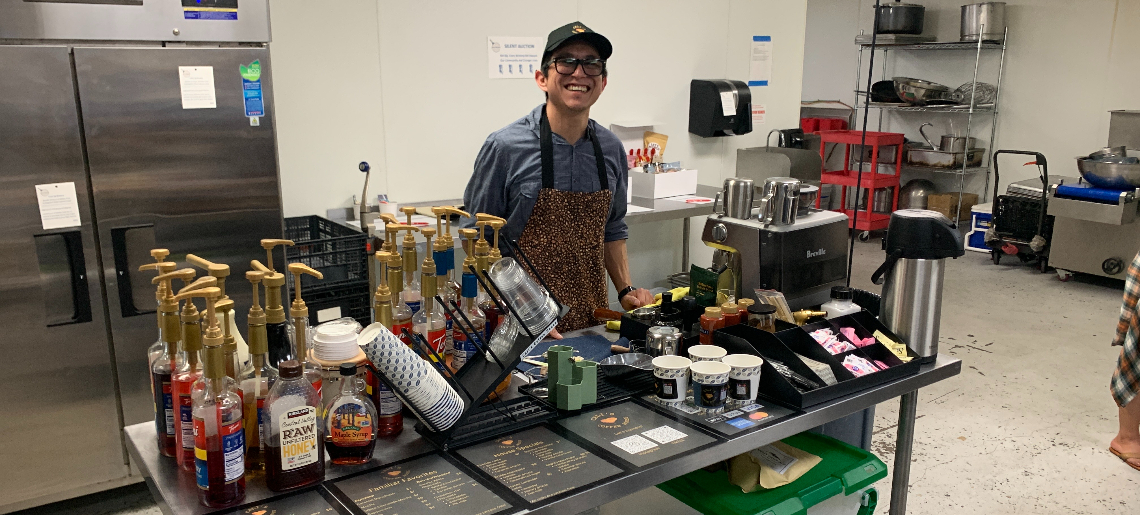 man behind a coffee bar