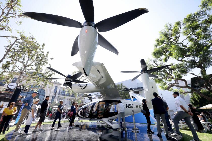 People inspect Joby Aviation's flying taxi in the Fairfax District.