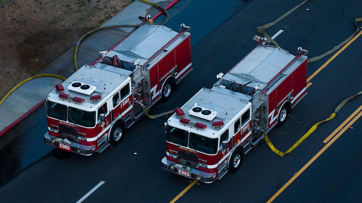 Firefighter trucks pumping water to a chemical tank at an aerospace plant