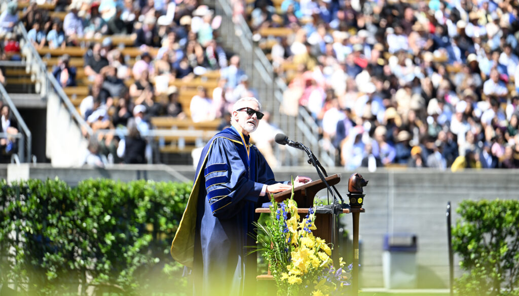 Chancellor Richard Lyons addresses the graduates from the podium