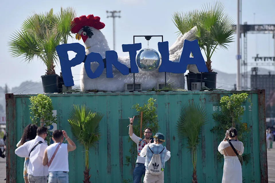 Festival goers pose in front of a chicken-themed art installation at the Portola Music Festival on Saturday, Sept. 30, 2023. (Charles Russo/SFGATE)