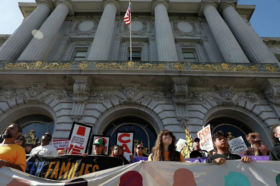 Demonstrators rally at City Hall as people protest against potential federal deployment in San Francisco on Thursday, October 23, 2025, in San Francisco. (Lea Suzuki/S.F. Chronicle)