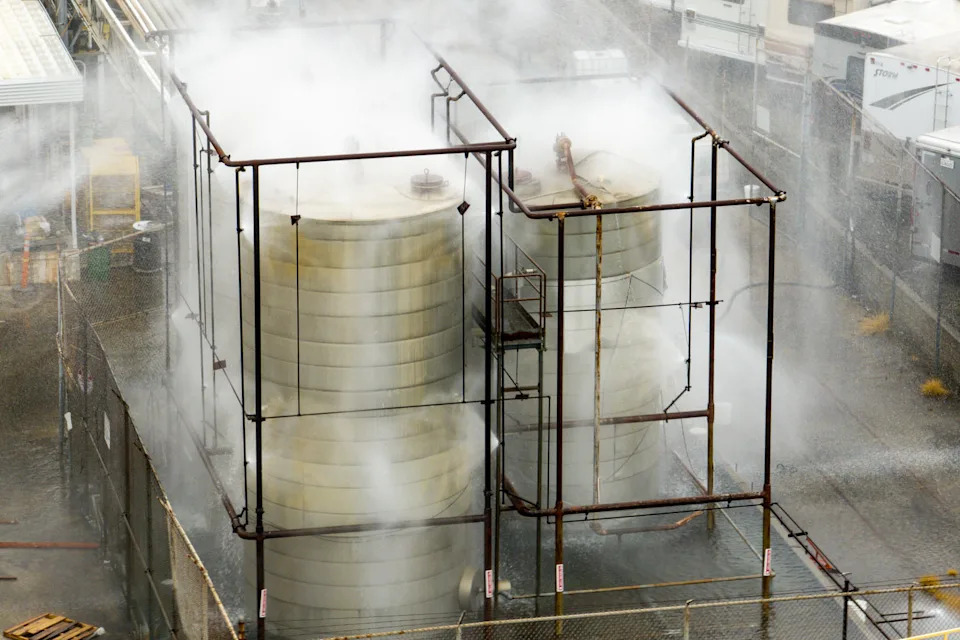Steam and mist rising off of industrial tanks. (Kayla Bartkowski / Los Angeles Times via Getty Images)