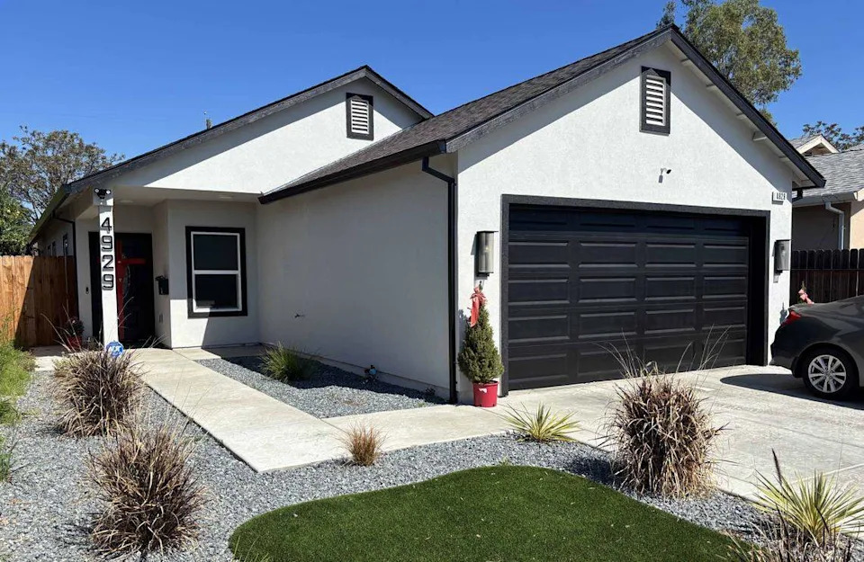 A recently constructed home, photographed in March 2026, stands at 4929 Baker Ave. in Sacramento County. The property was a vacant parcel when it was sold in a 2022 tax auction for $87,997.