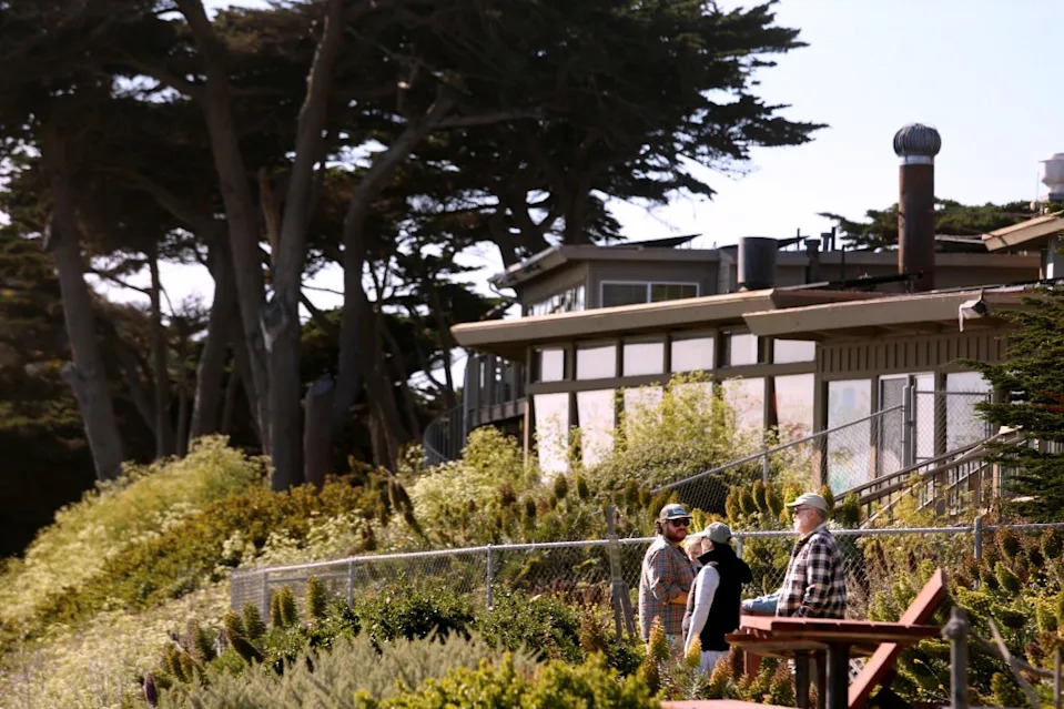 Visitors stand near the closed Rocky Point Restaurant in Big Sur. Los Angeles Times via Getty Images