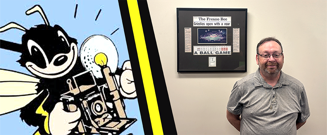 man stands next to a fresno bee framed page