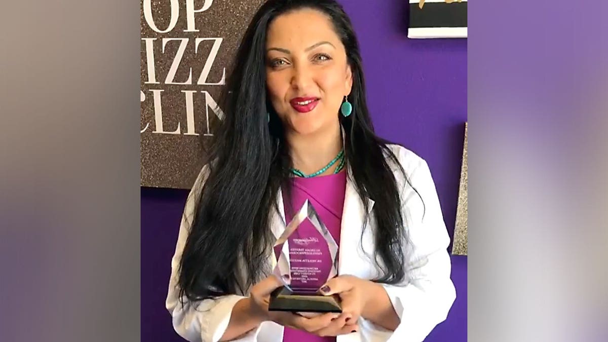 Dr. Violetta Mailyan holds an award.